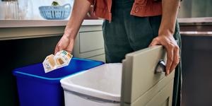 someone throwing packaging to recycling