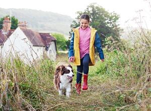 Girl and dog is walking